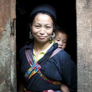 A Vietnamese woman is holding her baby