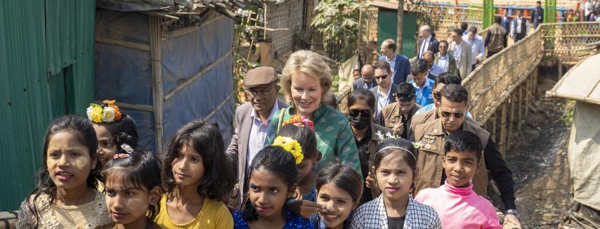 UN Secretary-General’s SDG Advocate Her Majesty Queen Mathilde and Rohingya children in front of a learning centre in the camps of Cox’s Bazar. Photo: UN/Saikat Mojumder