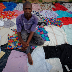 A young man selling shirts on a market in Lilongwe, capital of Malawi. ©Marcel Crozet/ILO 