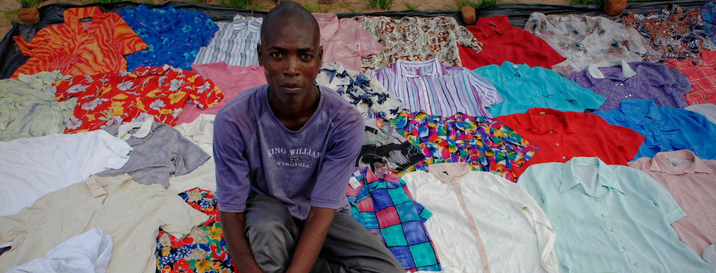A young man selling shirts on a market in Lilongwe, capital of Malawi. ©Marcel Crozet/ILO 