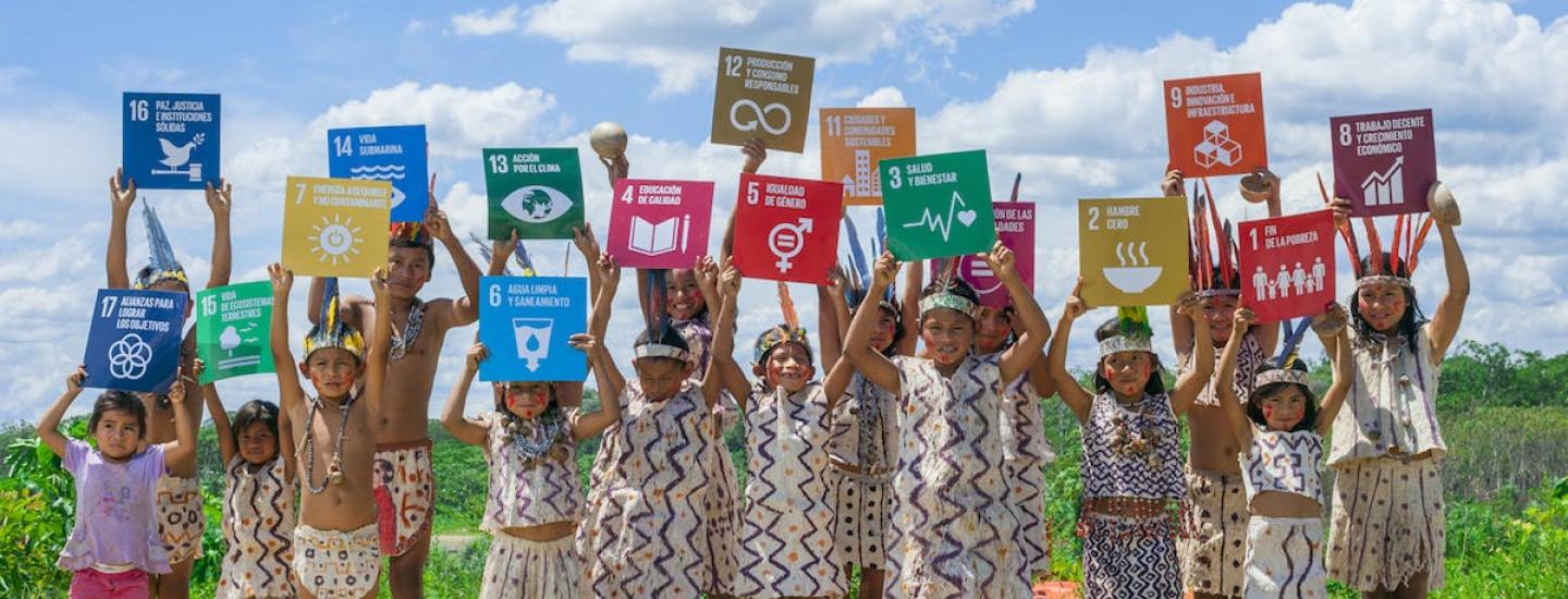 Children holding pictures of Sustainable Development Goals